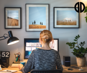 Woman working from home at her desk in front of her computer