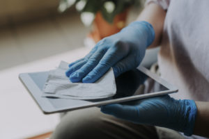 an asian chinese female Hands with latex glove wiping digital tablet
