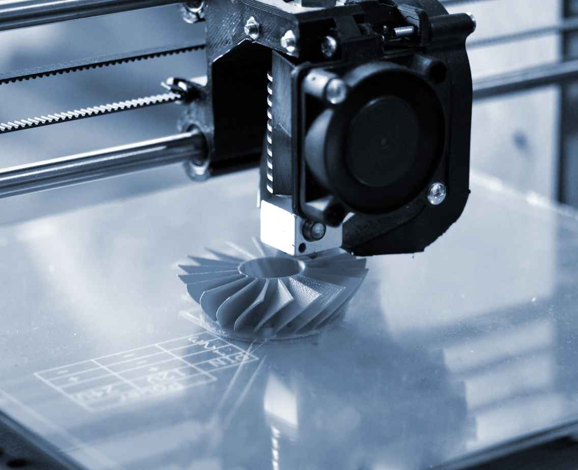 3D printer prints blue shapes on a blue backgroun close-up