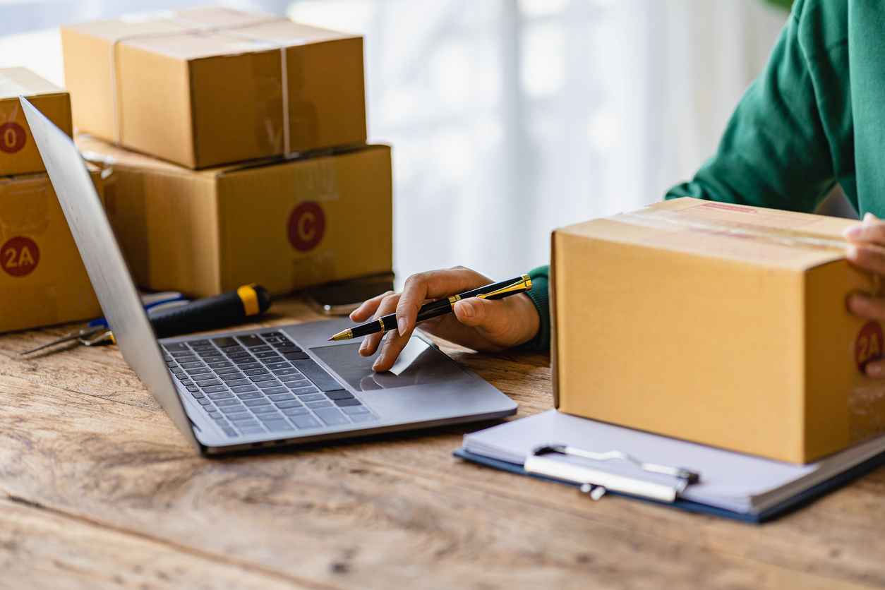 Startup or Small Business Entrepreneur prepare to deliver with parcel box note delivery address from customer, manage orders in online store, internet shopping, SME business concept, e-commerce.